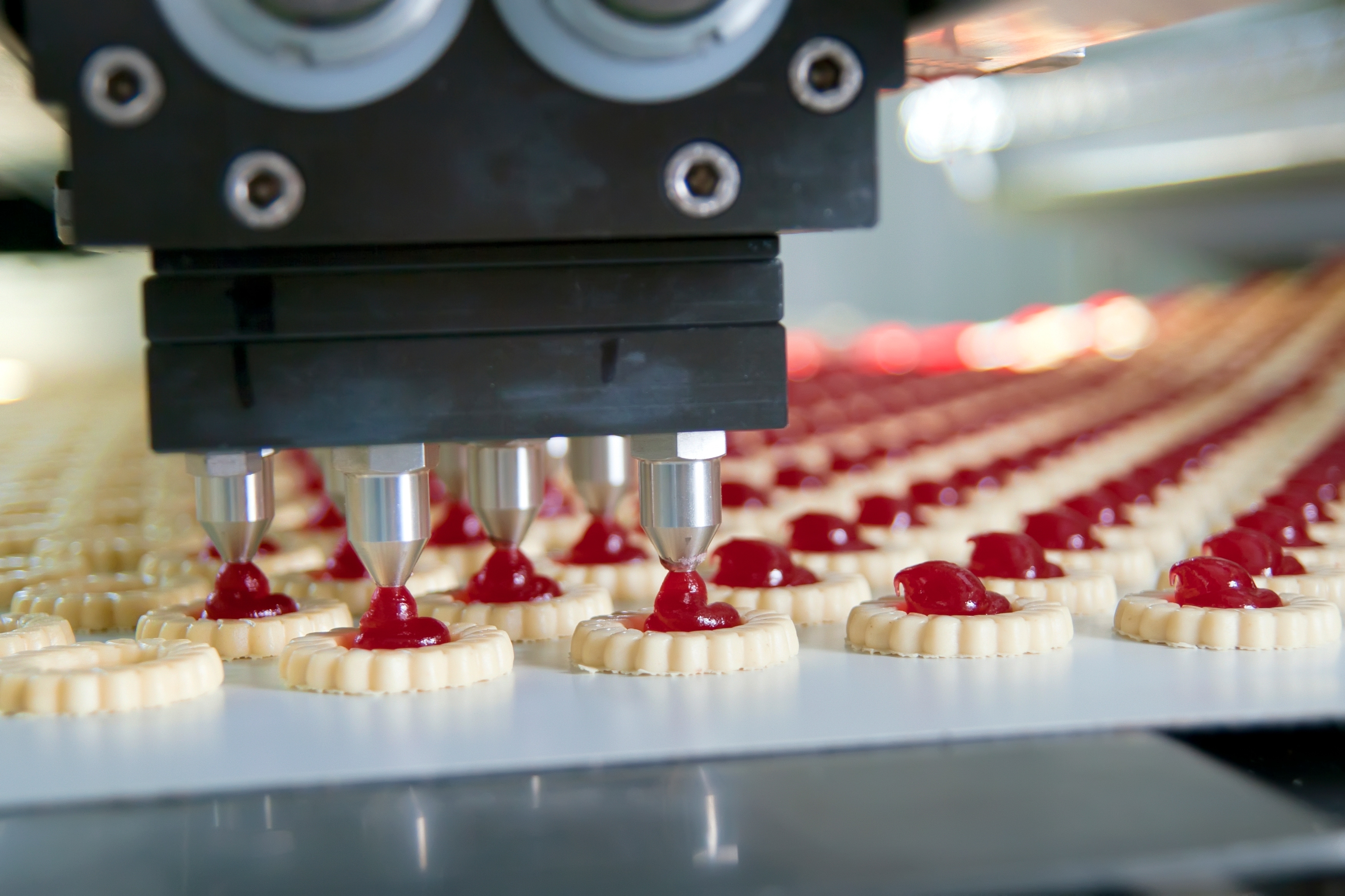 Machine filling desserts on the line